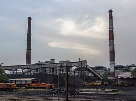 Piles of coal and smokestacks near a coal-fired thermal power station in Badarpur, Delhi | Photo: Prashanth Vishwanathan | Bloomberg File Photo