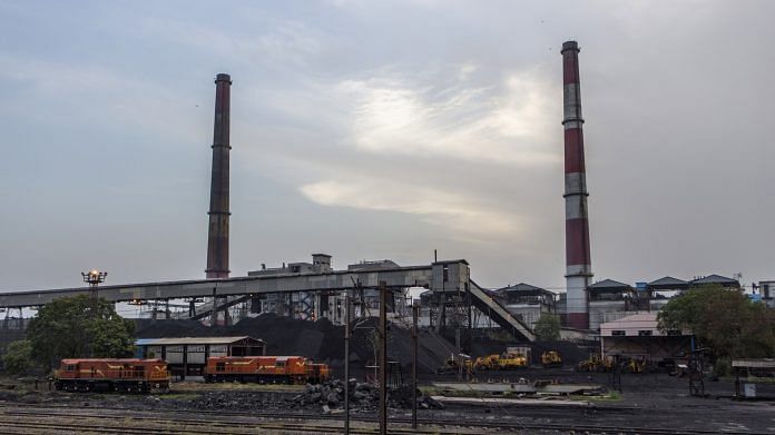 Piles of coal and smokestacks near a coal-fired thermal power station in Badarpur, Delhi | Photo: Prashanth Vishwanathan | Bloomberg File Photo