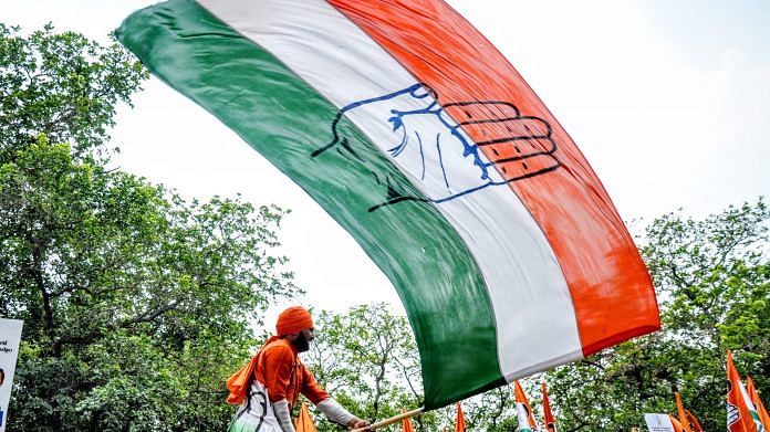 A Congress supporter waves a party flag | Representational image | ANI File Photo