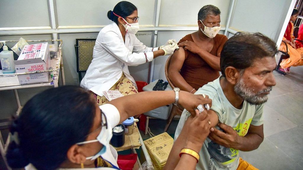 Health workers administer Covid-19 vaccines at a special vaccination camp targeting 1 lakh doses in a single day, in Bikaner, on 8 September 2021 | PTI