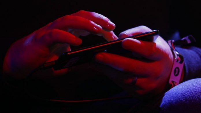 Representational image of a person playing a game on his mobile | Bloomberg
