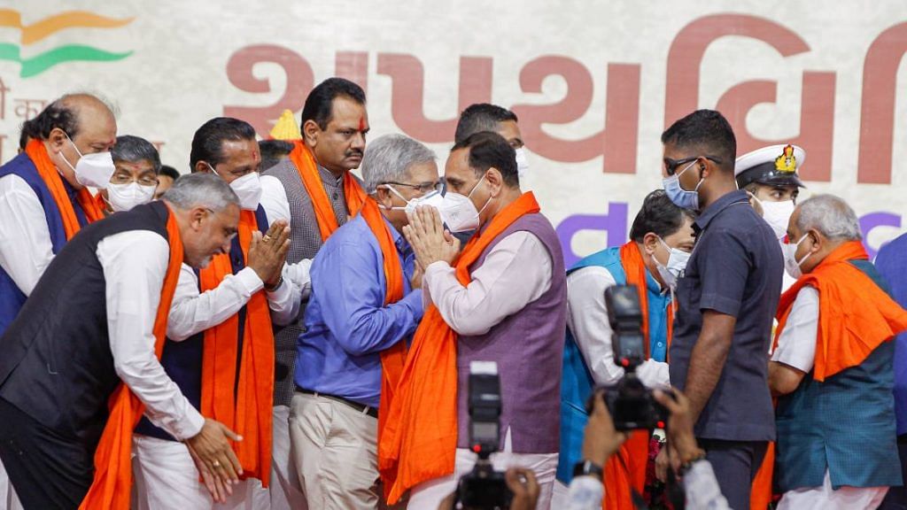Newly sworn-in Gujarat cabinet members and former state CM Vijay Rupani after the cabinet swearing in Thursday | PTI