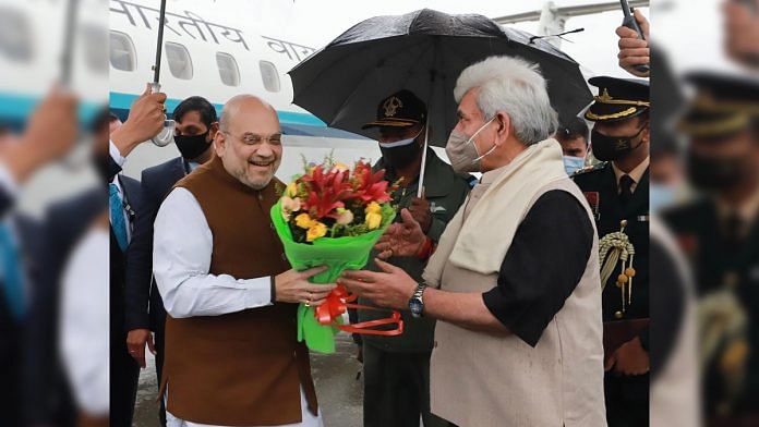 Union Home Minister Amit Shah being received by LG of J&K Manoj Sinha on his arrival in Srinagar, on 23 October 2021 | PTI