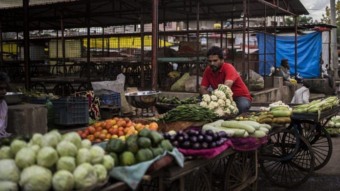 A vendor at a vegetable and fruit wholesale market in Guna, Madhya Pradesh | Photographer: Anindito Mukherjee | Bloomberg