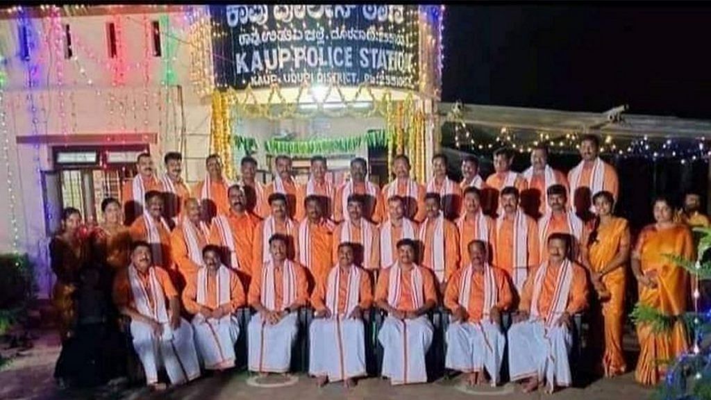 Police personnel dressed in saffron pose outside the Kaup police station in Udupi on the festival of Ayudha Pooja last week | Photo: Twitter | @siddaramaiah