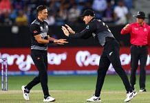 New Zealand fast bowler Trent Boult (left) celebrates a wicket with teammate Martin Guptill in their ICC Men's Twenty20 World Cup match against India in Dubai Sunday | Photo: Twitter | @BLACKCAPS