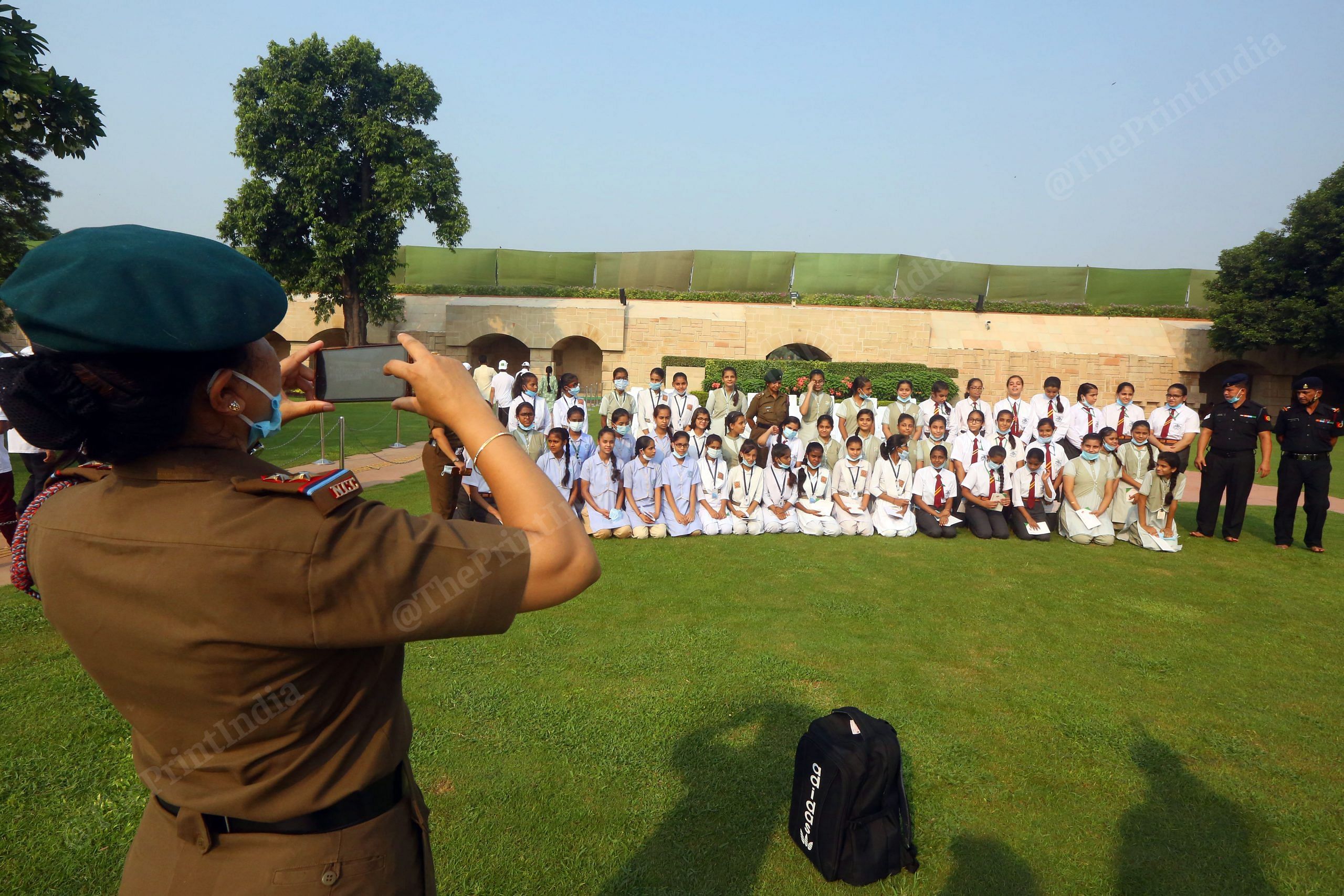 A National Cadet Corps (NCC) member clicks photographs of students on the occasion of Gandhi Jayanti at Raj Ghat | Photo: Praveen Jain | ThePrint