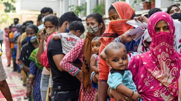 Beneficiaries wait to receive Covid-19 vaccine dose at a free vaccination camp organized by the Delhi government, on 10 October 2021 | PTI