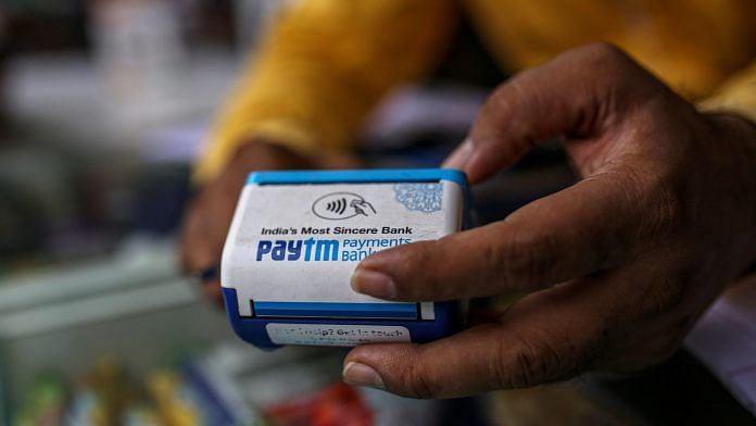 A storekeeper uses a Paytm All-In-One POS payment device at a medical store in Mumbai | Photo: Dhiraj Singh | Bloomberg