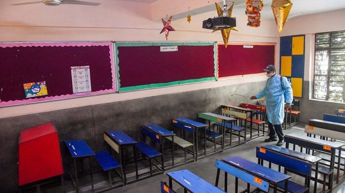 Workers sanitize the classroom at Vidya Bal Bhawan Senior Secondary School in New Delhi on 31 October 2021 | ANI photo