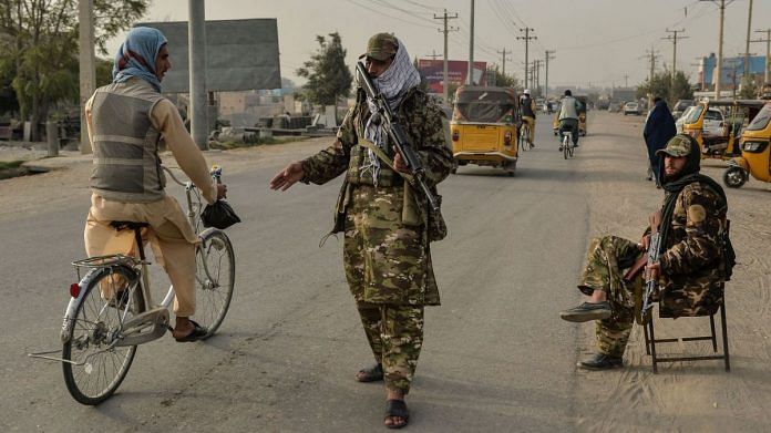 Taliban fighters check commuters along a road in Afghanistan's Kunduz on October 10 2021 |Photographer: Hoshang Hashimi/AFP/Getty Images via Bloomberg