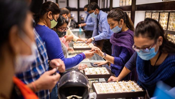 Customers shop for gold during the festival of Dhanteras in Noida | Bloomberg