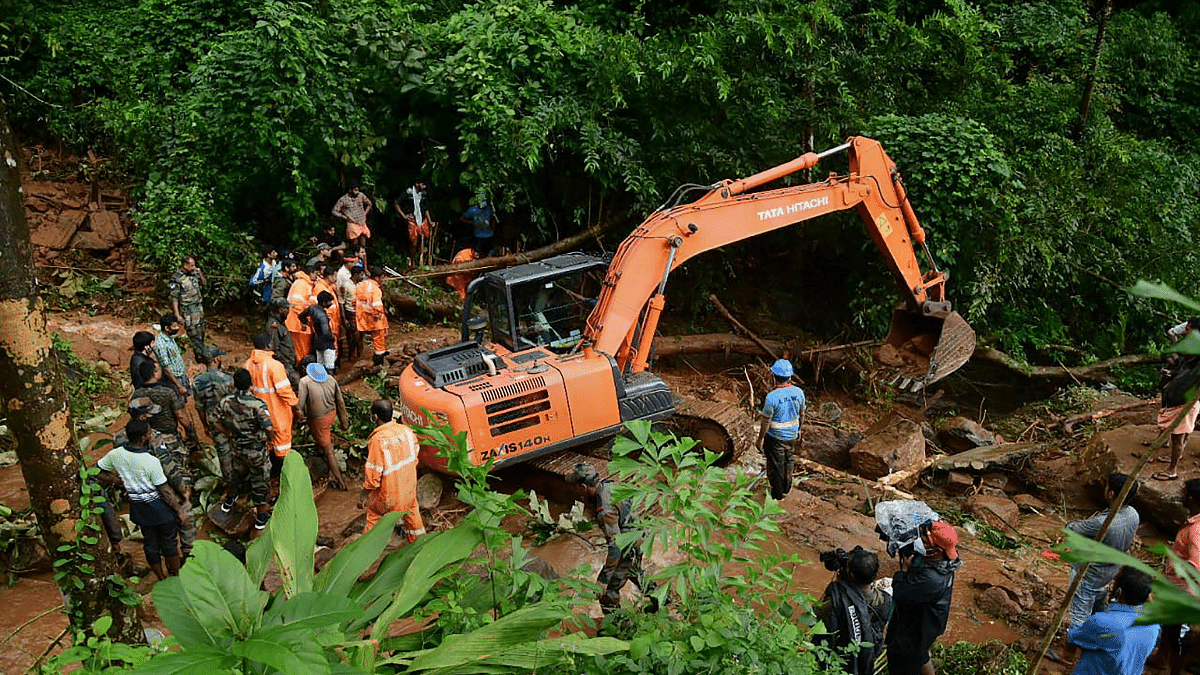Rapid Action Force and Kerala Fire and Rescue personnel during rescue operations at the site of landslide at Kavali in Kottayam district, on 17 October 2021 | PTI Photo