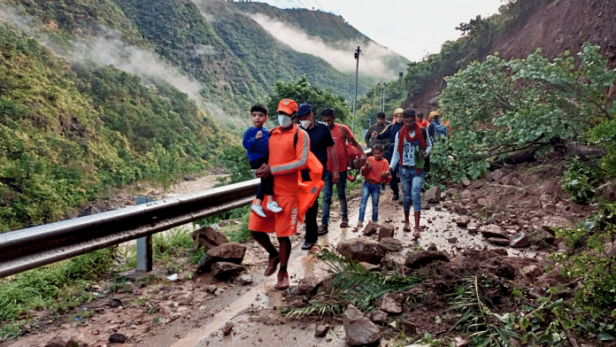 Stranded tourists being evacuated by the NDRF following heavy rains, in Nainital, October 20 |PTI Photo|