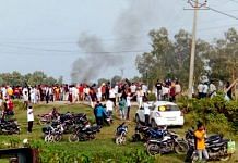 A vehicle set ablaze after violence broke out after farmers agitating were allegedly run over by a vehicle in the convoy of a union minister, in Lakhimpur Kheri on 3 October 2021 | PTI