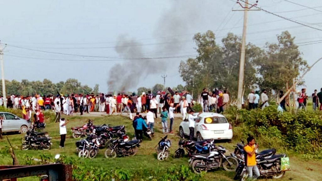 A vehicle set ablaze after violence broke out after farmers agitating were allegedly run over by a vehicle in the convoy of a union minister, in Lakhimpur Kheri on 3 October 2021 | PTI