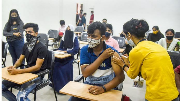 File photo of a health worker giving a dose of Covid-19 vaccine to college students in Mumbai | Photo: PTI