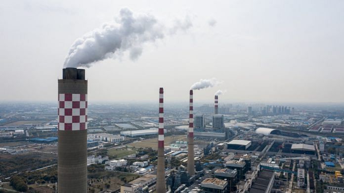 Exhaust rises from the smoke stacks of thermal power plants in this aerial photograph taken in Changshu, Jiangsu Province, China| Bloomberg