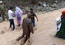 Police personnel rescue stranded devotees who were going to Shri Maa Poornagiri Darshan, amid heavy rains in Uttarakhand| ANI