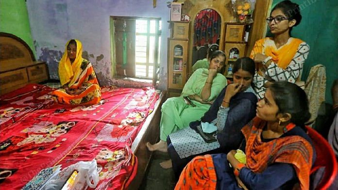 Raman Kashyap's widow Aradhana sits with relatives gathered at the family home in Nighasen, Lakhimpur Kheri, after the journalist's death | Praveen Jain | ThePrint