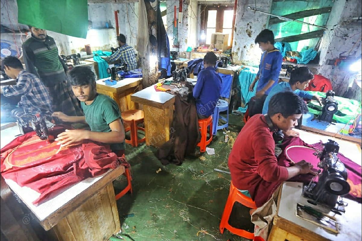 Migrant workers do embroidery work at a warehouse in Zaina Kadal | Praveen Jain | ThePrint