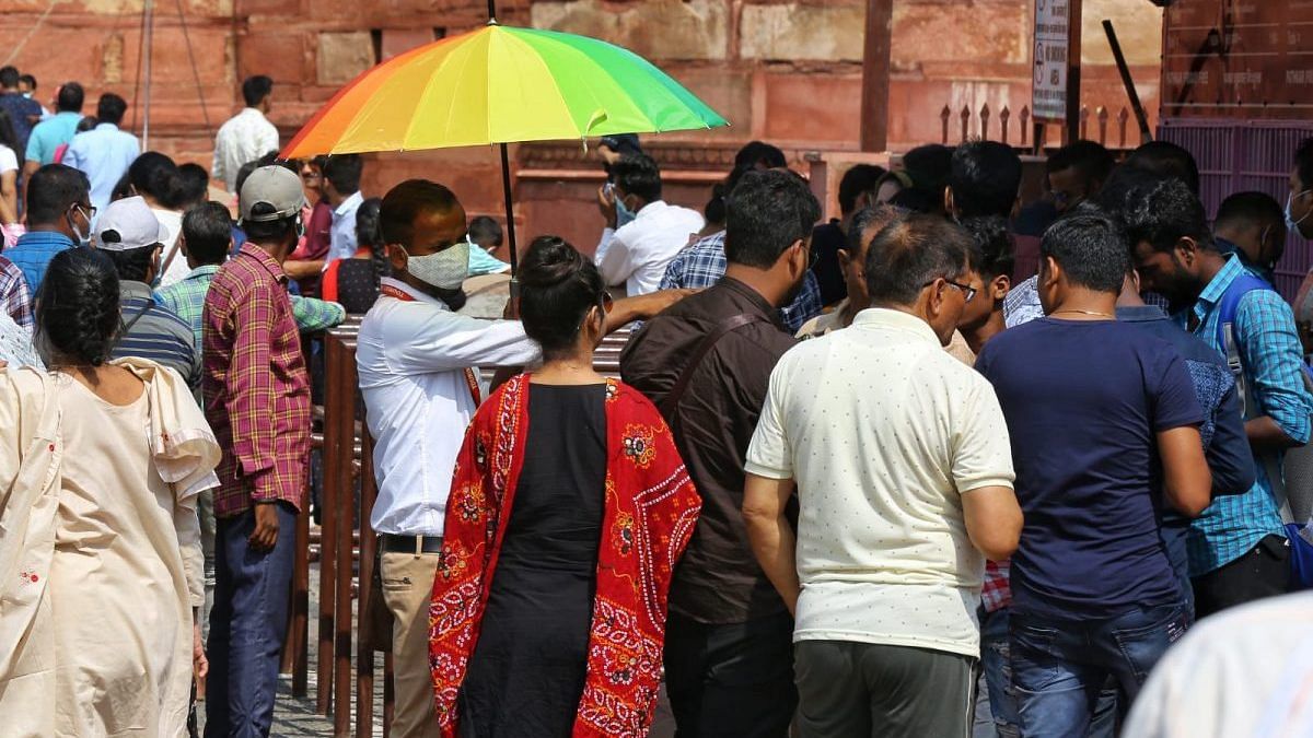 Guide Salman Khan (holding umbrella) looks to woo domestic tourists at Agra's Red Fort | Photo: Suraj Singh Bisht/ThePrint