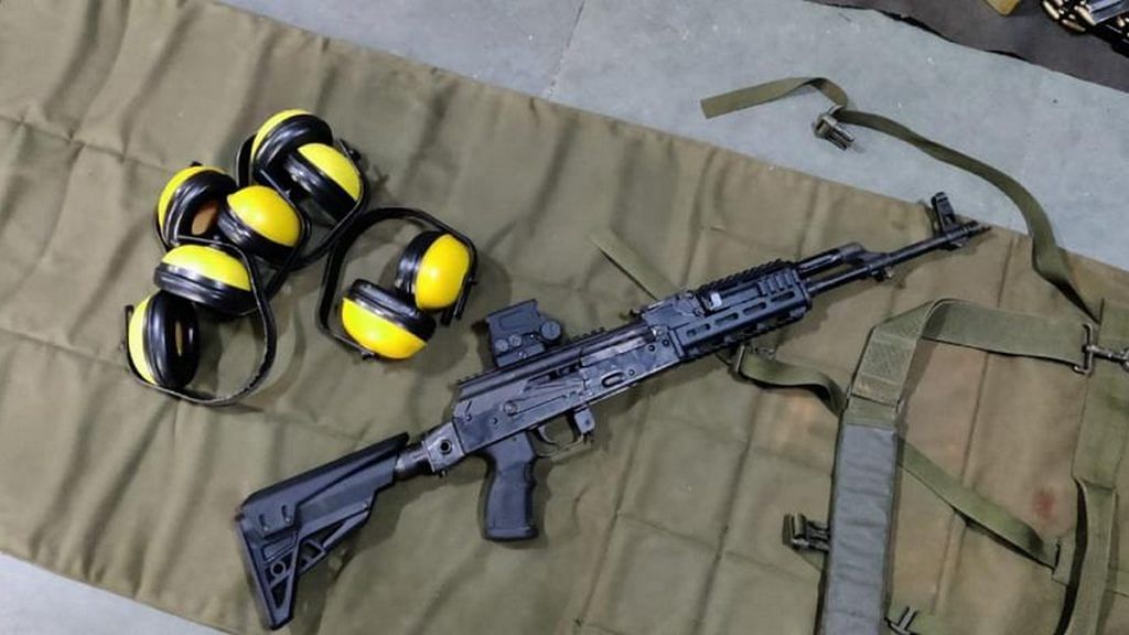 An upgraded AK-47, with earmuffs lying next to it | By special arrangement