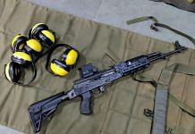 An upgraded AK-47, with earmuffs lying next to it | By special arrangement