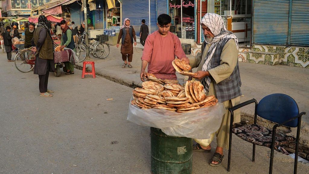 A baker sells bread along a road in Kunduz , Afghanistan on 10 October 2021