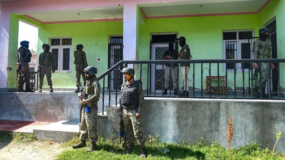 Security personnel stand guard at the Government Boys Higher Secondary School after militants shot dead two teachers including a female, at Eidgah Sangam area of Srinagar, on 7 October 2021 | PTI Security personnel stand guard at the Government Boys Higher Secondary School after militants shot dead two teachers including a female, at Eidgah Sangam area of Srinagar, on 7 October 2021 | PTI