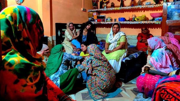Nisha and Sooraj Dahiya's sisters are comforted by relatives at the family's home in Sonepat's Halalpur village | Sukriti Vats | ThePrint