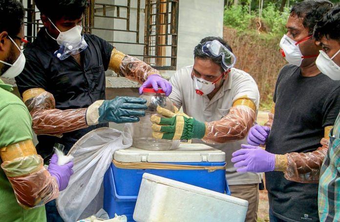 File photo of Animal Husbandry department and forest officials collecting bats from a well of a house after the outbreak of 'Nipah' virus in Kerala| PTI
