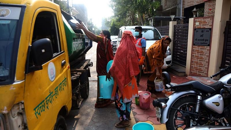 Women dispose of already segregated waste in different compartments. All municipal trucks for home collection have different compartments for dry and wet waste | Photo: Manisha Mondal/ThePrint