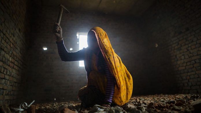 Representational image | A labourer uses a hammer to break bricks at the construction site of a house in Noida | Prashanth Vishwanathan/Bloomberg
