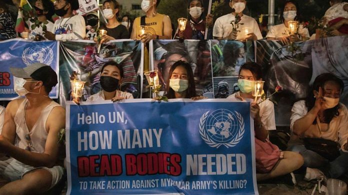 Demonstrators hold up banners during a protest against the Myanmar military coup outside United Nations Building in Bangkok | Representational image | Bloomberg