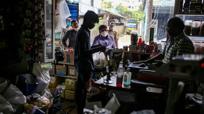 Customers stand at a counter while shopping at a grocery store in Bengaluru | Representational image | Bloomberg