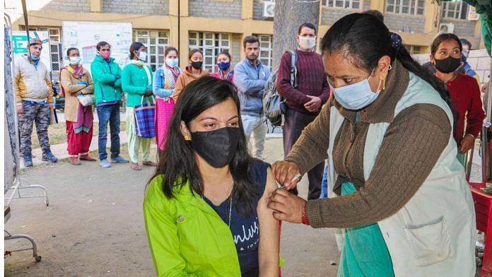 A health worker inoculates a dose of Covid-19 vaccine to a beneficiary, in Kullu on 17 November 2021| PTI
