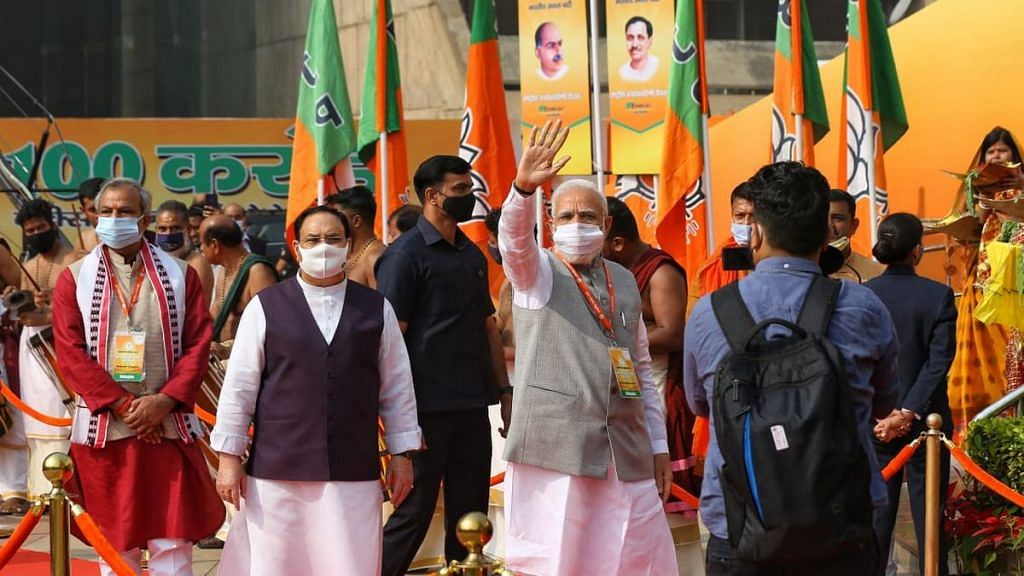 Prime Miniser Narendra Modi waves to supporters with BJP chief J.P. Nadda alongside him | Photo: Suraj Singh Bisht | ThePrint