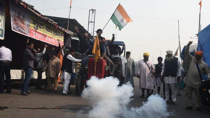 Farmers at the Ghazipur border celebrate the Centre's repeal of the farm laws Friday | ThePrint