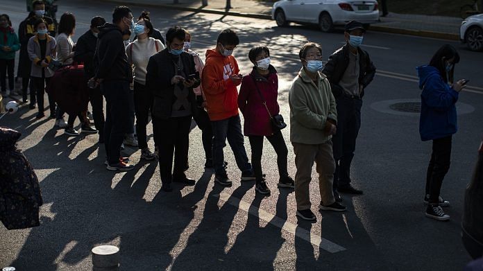 Residents line up to receive Covid vaccine in Wuhan 18 November 2021 | Bloomberg