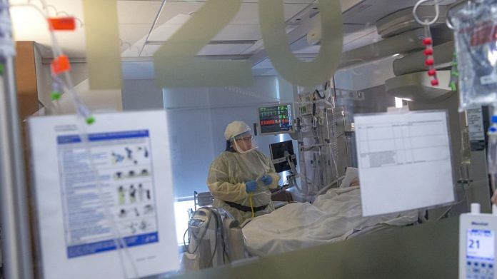 A nurse treating a patient inside the Covid-19 intensive care unit in Vancouver (file photo) | Bloomberg