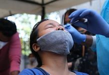 A medical worker collects sample for Covid-19 testing in New Delhi on 21 October 2021 | Bloomberg