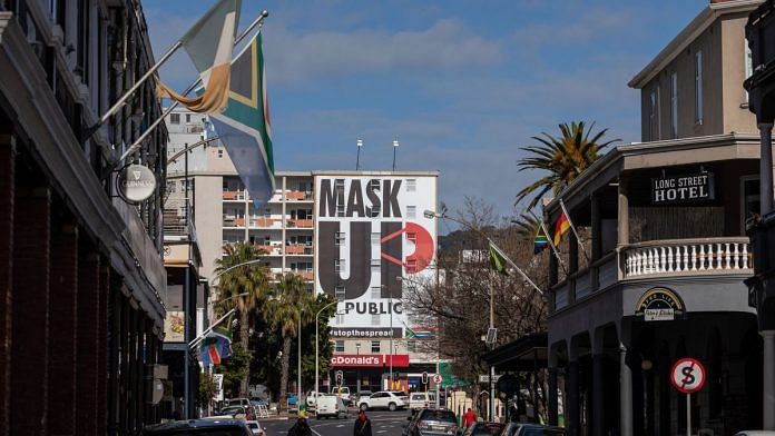 A 'mask up' billboard covers the front of a building on Long Street in Cape Town | Photographer: Dwayne Senior | Bloomberg