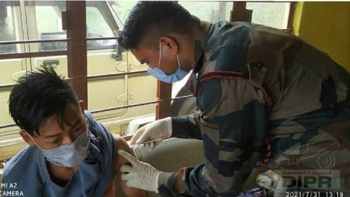 A medical personnel from 41 Battalion Assam Rifles, vaccinates a beneficiary during a special camp organised in July in Kiphire. | Twitter | @dipr_nagaland