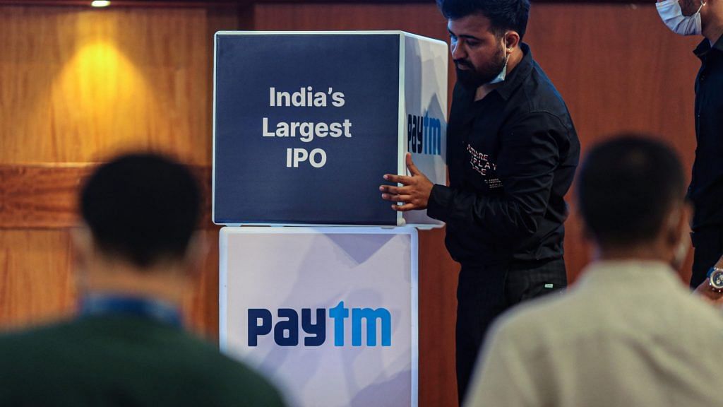 Workers prepare the stage during the listing ceremony for the IPO of One97 Communications, operator of PayTM, at the Bombay Stock Exchange in Mumbai on 18 November 2021 | Bloomberg
