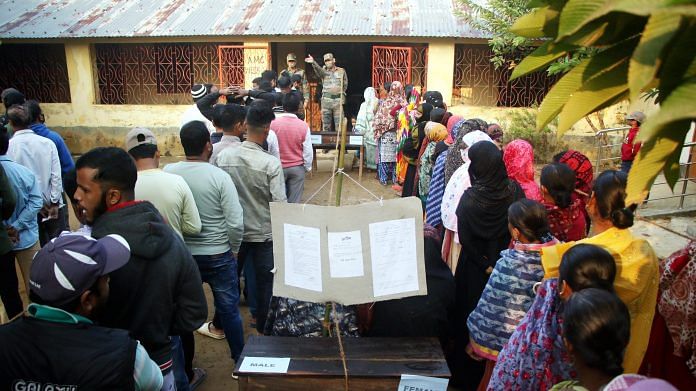 People wait outside a polling station in Agartala, on 25 November 2021 | PTI Photo
