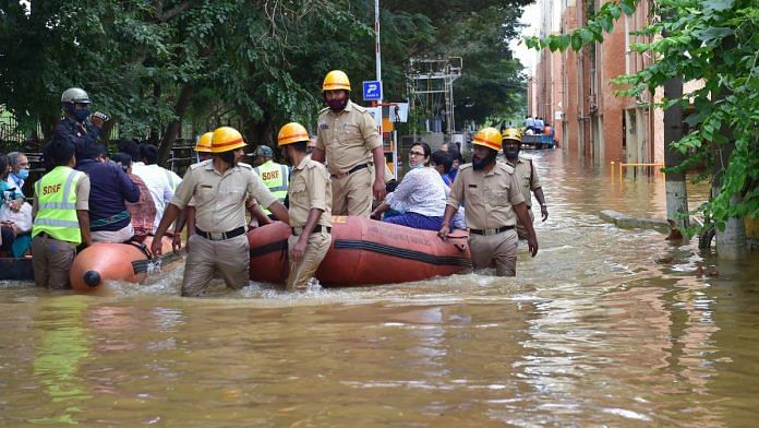 Emergency services personnel deploy inflatable boats to evacuate stranded apartment residents in Bengaluru | PTI
