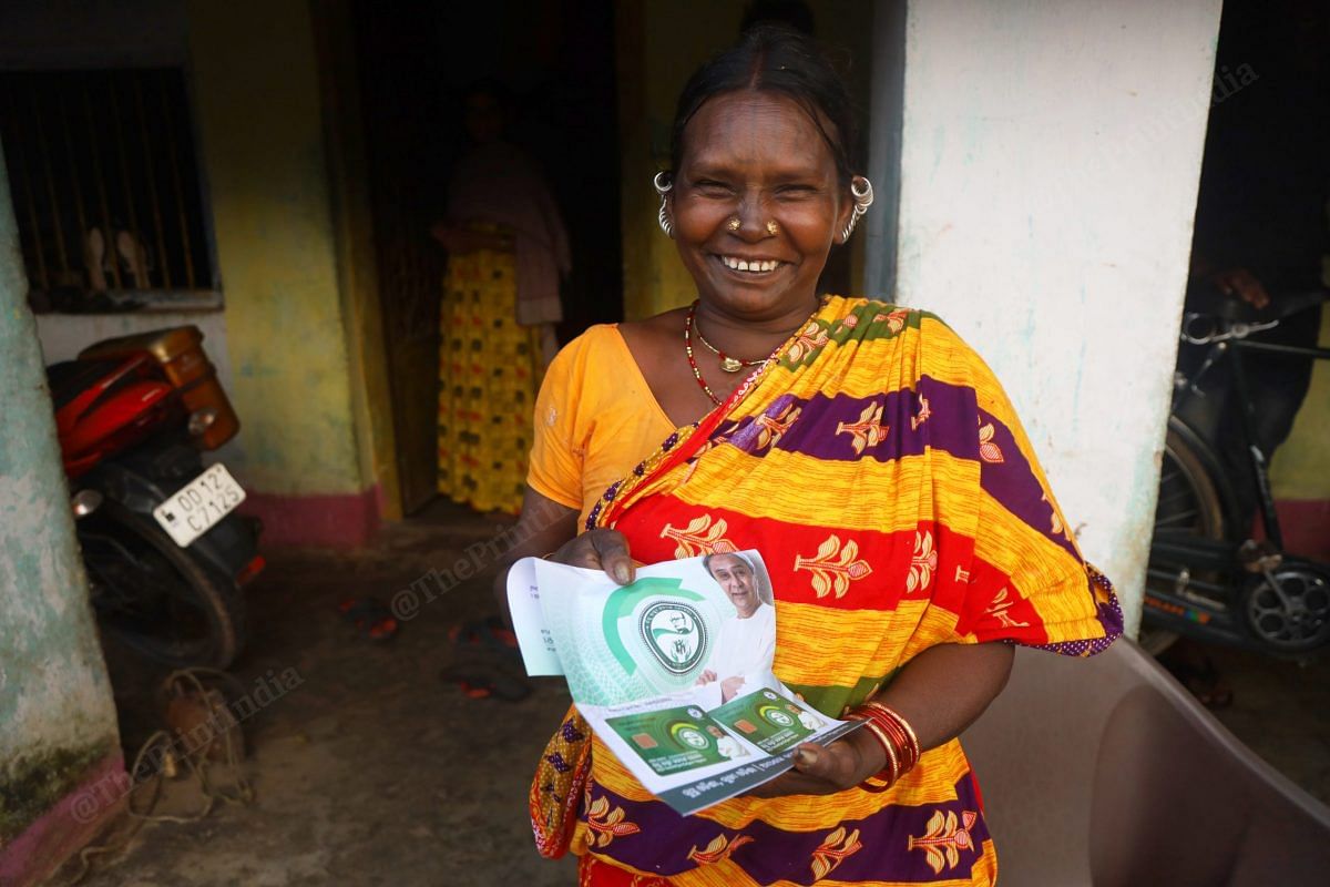 A tribal woman shows the BSKU smart health card | Photo: Manisha Mondal | ThePrint