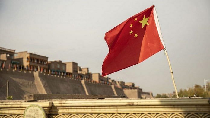 A Chinese flag flies outside the east gate of the Old City in Kashgar, Xinjiang autonomous region, China | Representational image | Qilai Shen | Bloomberg