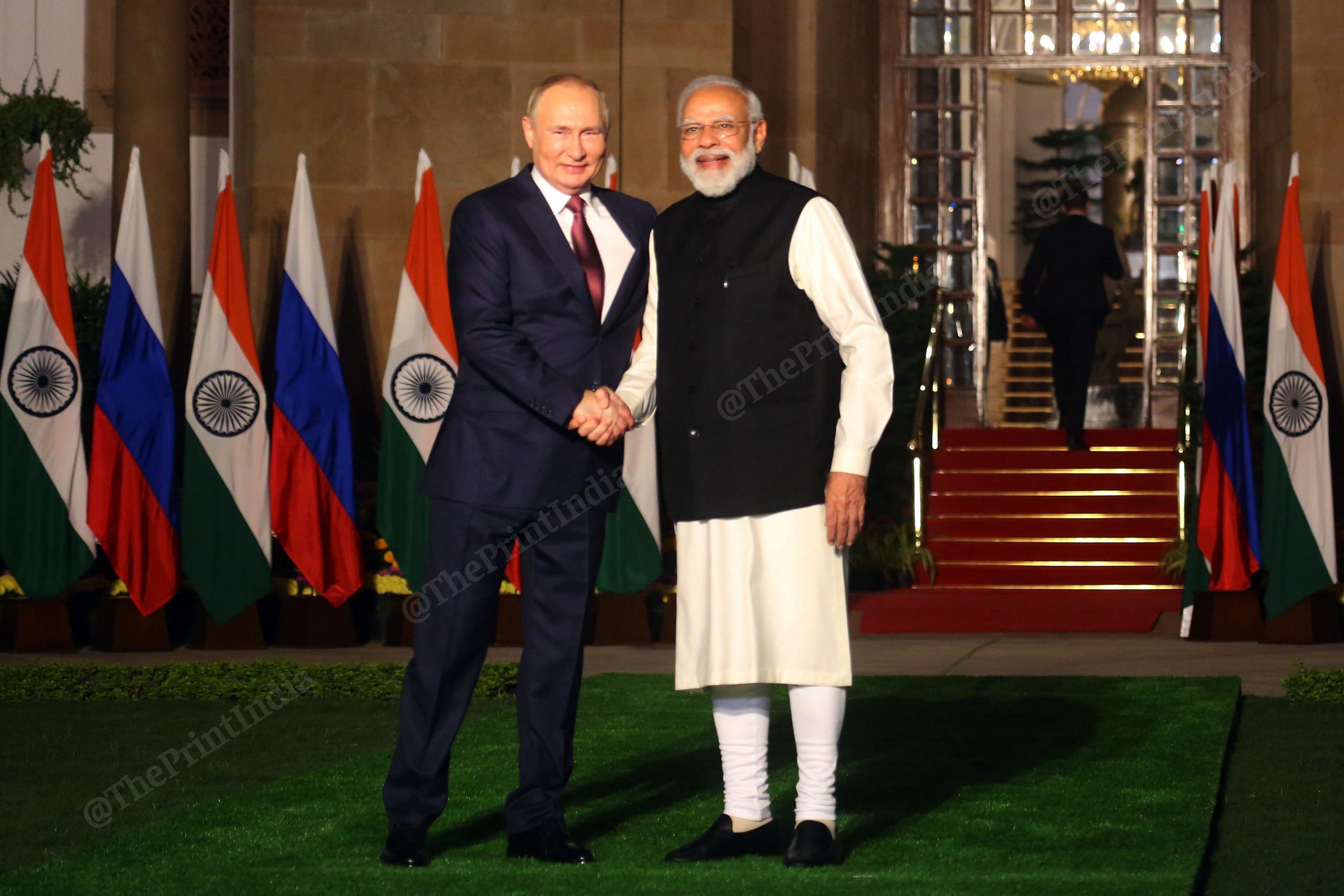 One for the shutterbugs: PM Modi and President Putin shake hands as they pose for photos outside Hyderabad House| Photo: Praveen Jain | ThePrint